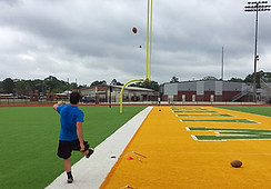 A Trinity Kicker works on accuracy drills by kickig at the uprigts.
