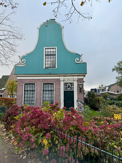 beautiful old green and white facade houses at Old Zaandijk, the Netherlands