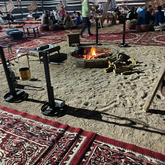 gathering around the fire at Mazayen desert camp in Wadi Rum, Jordan