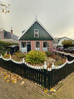 beautiful old green and white facade houses at Old Zaandijk, the Netherlands
