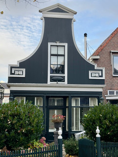 beautiful old green and white facade houses at Old Zaandijk, the Netherlands