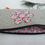 Thumbnail: Inside of grey fabric cosmetic bag with pink floral fabric