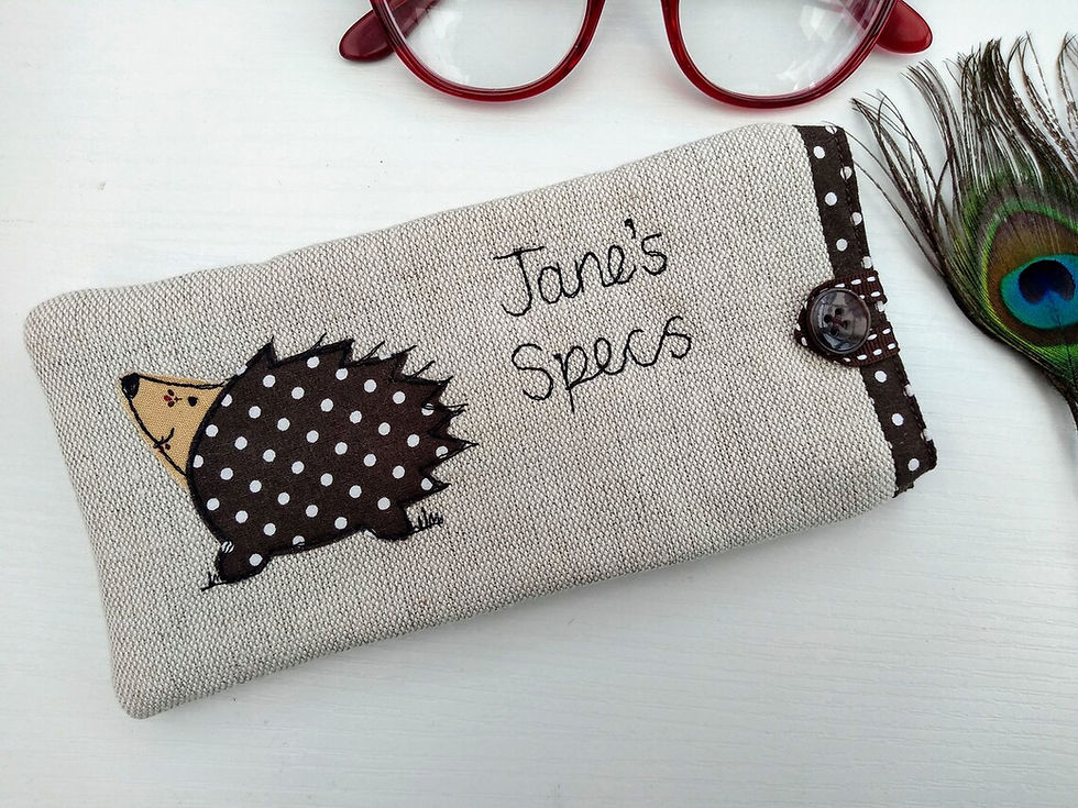 Thumbnail: Hedgehog motif applique on linen glasses spectacles sunglasses case.  Chocolate dot lining and fastened with  ribbon button