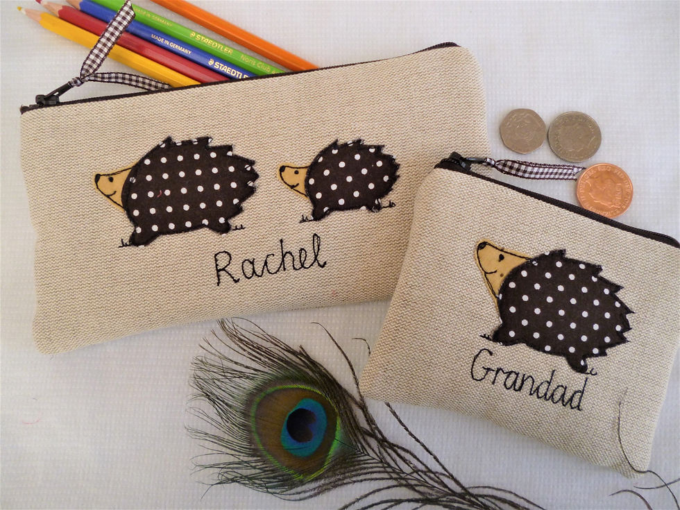 Thumbnail: Hedgehog motif applique on linen coin purse or wallet.  Chocolate dot lining and fastened with zip and ribbon pull