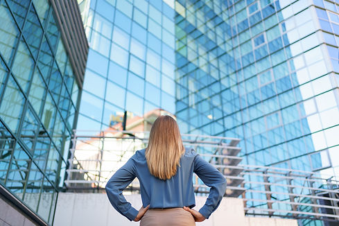 back-view-of-successful-manager-looking-at-business-building-of-modern-city.jpg