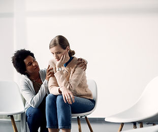 caring-african-american-woman-consoling-sad-woman-before-group-therapy-meeting.jpg