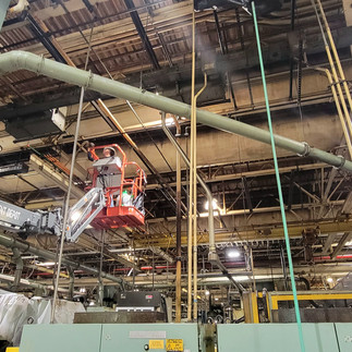 Man on a boom lift Rafters Cleaning MI