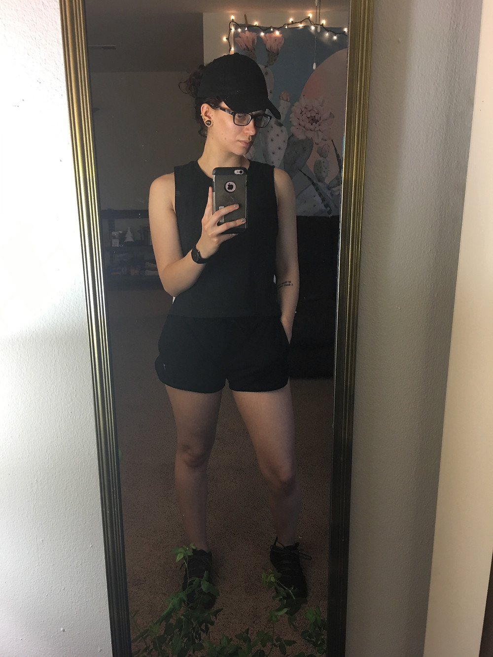 Black athletic shorts (with pockets, of course), a black sleeveless shirt from New Balance, the black baseball hat, and the black and gold Pumas
