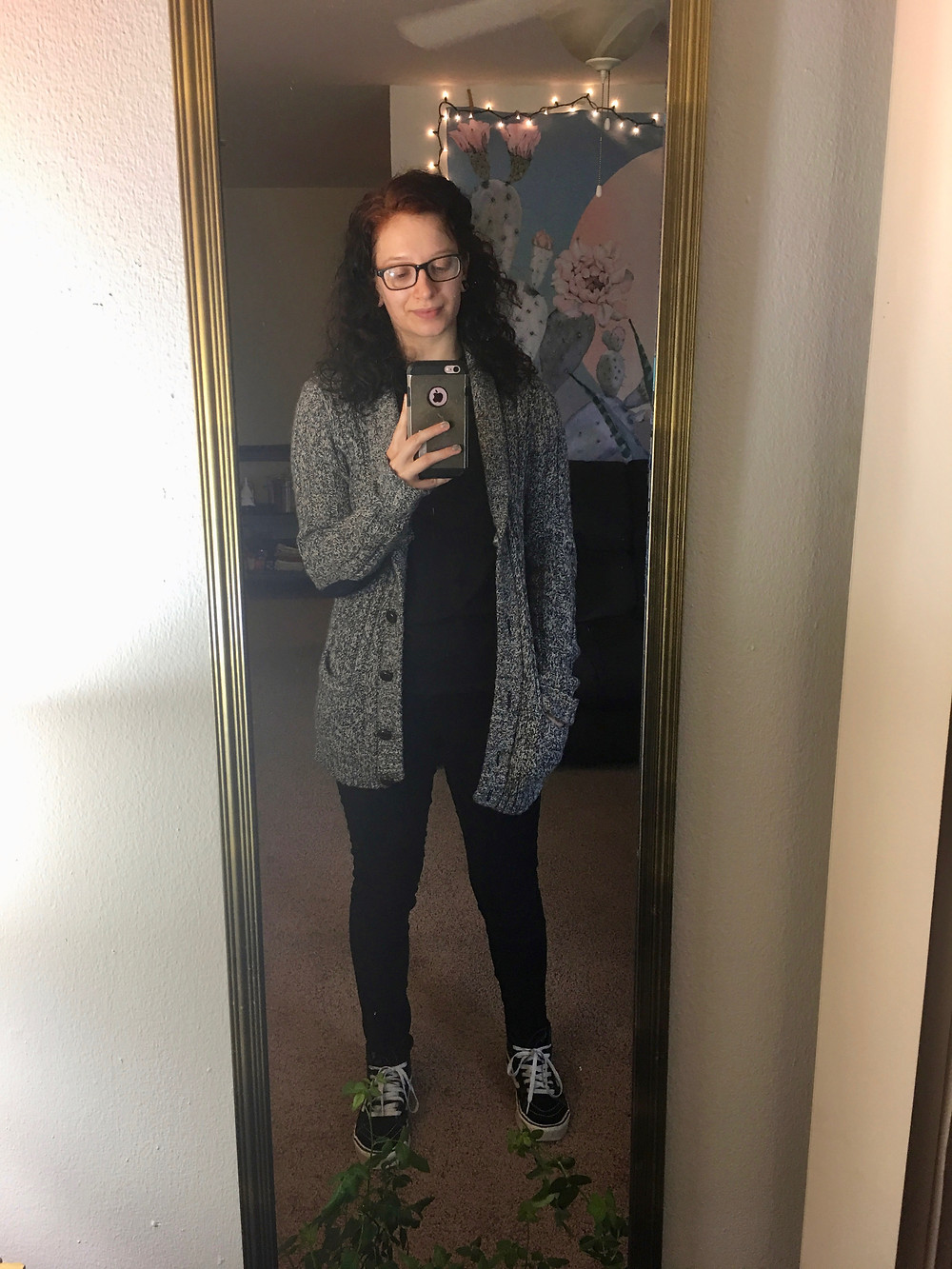 Black shirt, black jeans, black Vans, grey cardigan