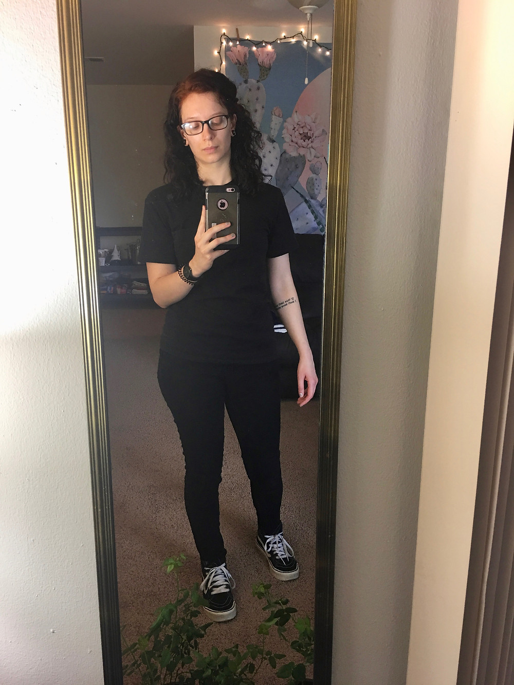 Black t-shirt, black jeans, classic black vans