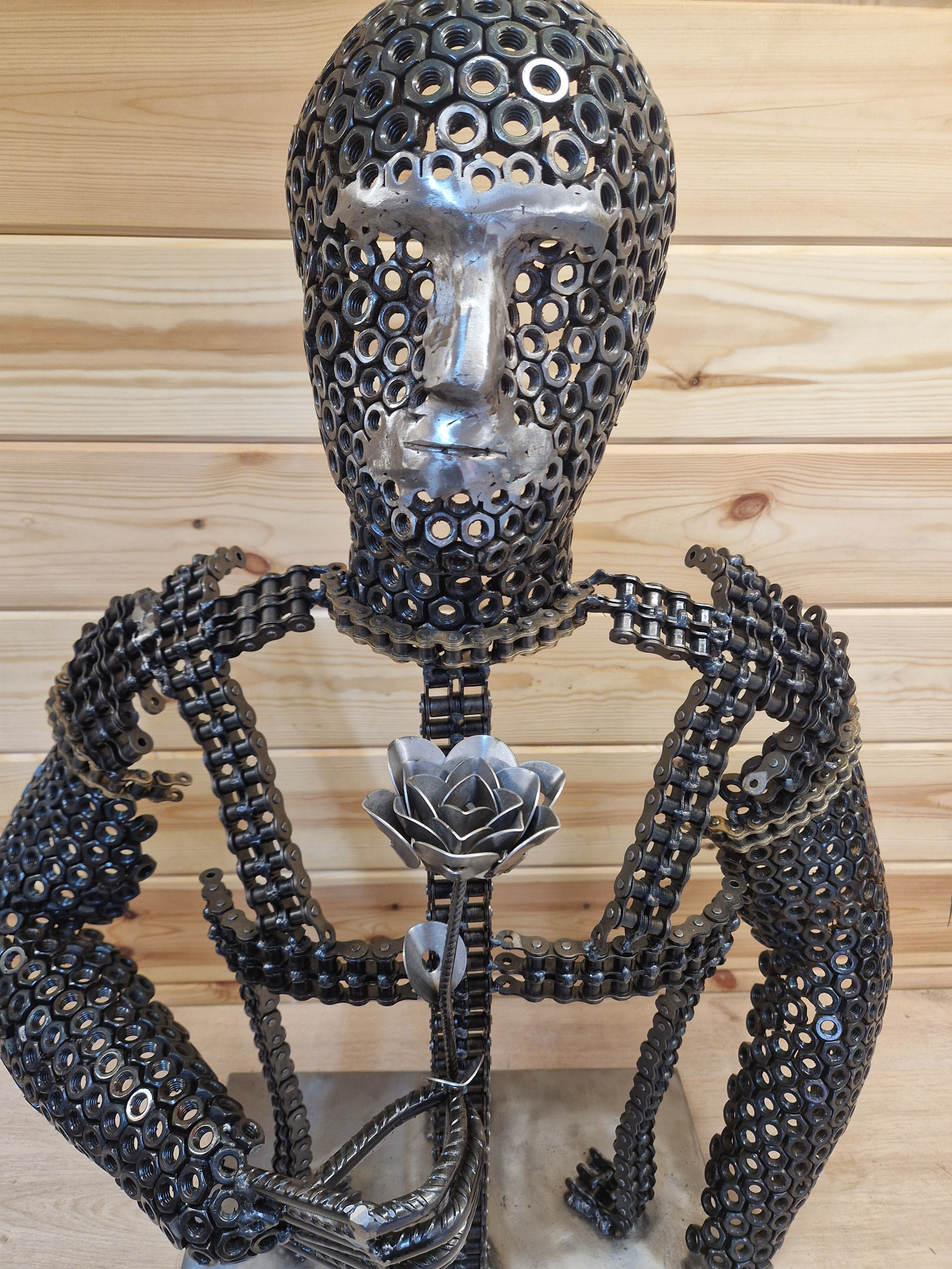 Steel sculpture made from chain and nuts with a rose