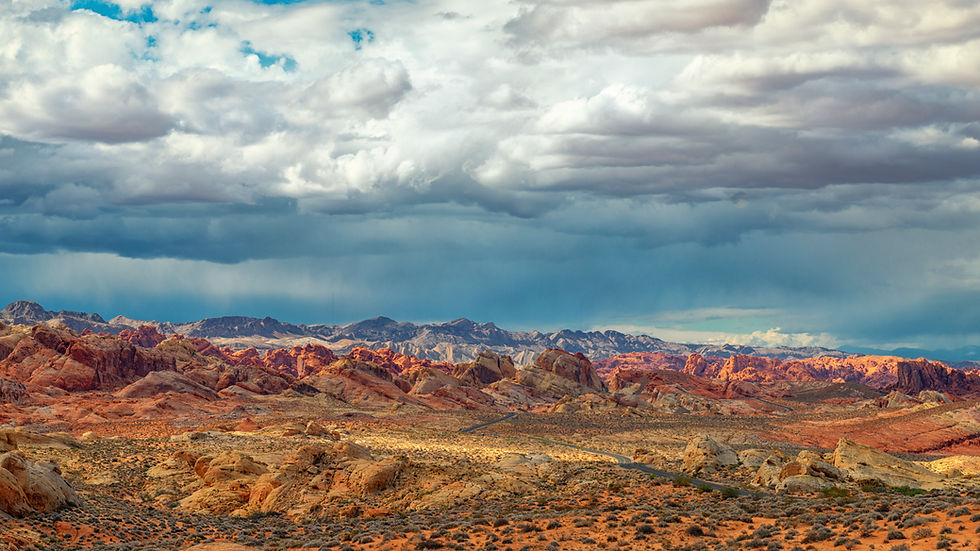 Stormy skies gather over the vibrant red rock formations of Valley of Fire State Park in Nevada, highlighting the dramatic beauty of a spring storm.