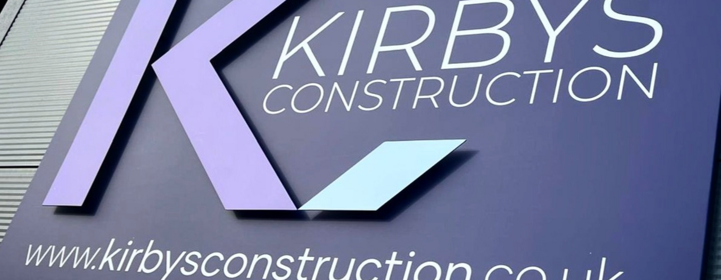 Large purple external sign with raised and vinyl letters