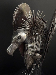 Vulture - Death Watch, by Simon Treseder, The vulture made from recycled metals rests in silence, patiently watching and waiting for its next victim—an ominous symbol of nature's cycle and the beauty found in decay.