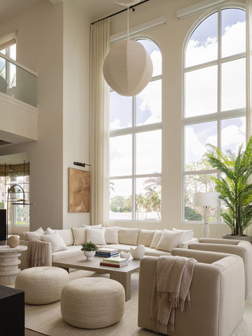 Living room seating area with oversized windows and airy palette, Naples, Florida