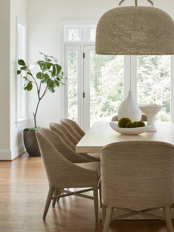 Breakfast nook in a Greenspring Valley home with woven dining chairs, neutral table, organic ceramics, and natural light