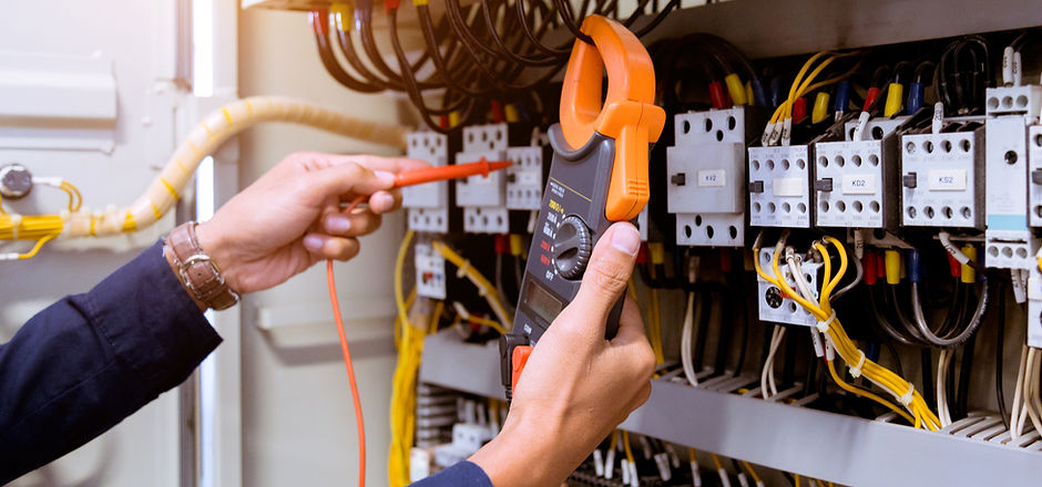 Electrician measurements with multimeter testing current electric in control panel..jpg