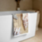 Large Sea Shell Beach Towel hanging off tub.