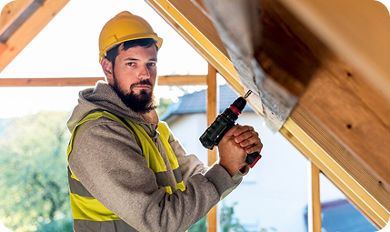 Construction worker using drill inside new house