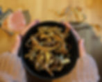 crispy vegetable peel in a black bowl held in hands