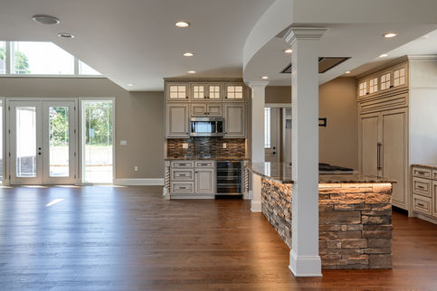 custom kitchen with stone island, granite countertops, hand made cabinets, and under lighting. 
