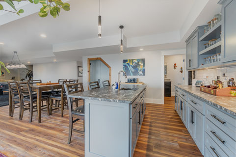 basement bar/2nd kitchen with island, granite counter tops, dining area, kegerator and wine cellar.