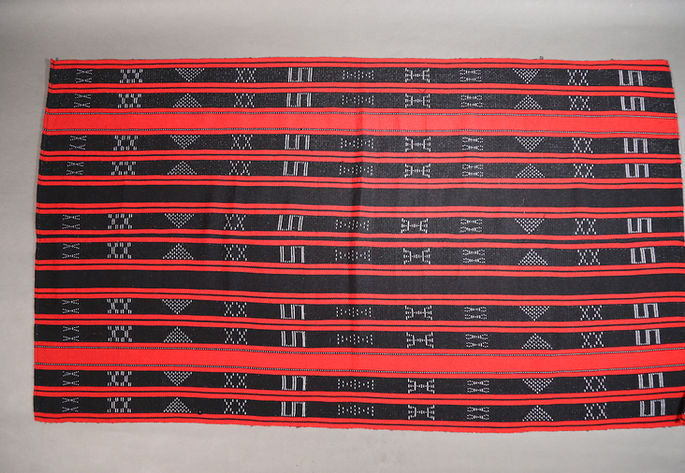 A feature shot of an Ifugao skirt with black and red stripes and traditional motifs