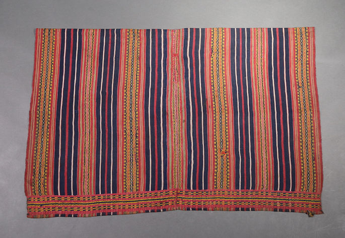 A hero shot of a terracotta-colored skirt in two panels, featuring indigo, white, and red stripes