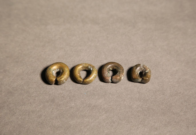 A hero shot of a set of brass barter rings, uniform in size and form