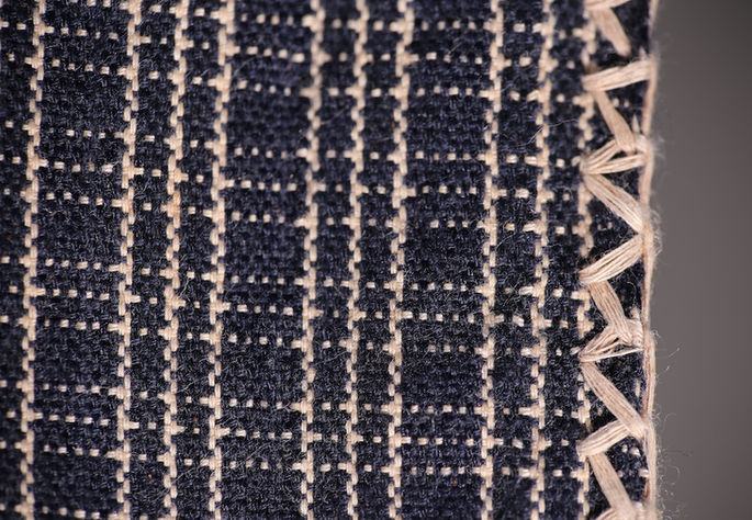 The edges of this skirt are embroidered with zigzag patterns to secure its warp and weft threads