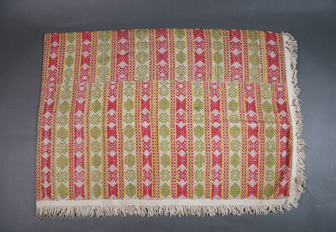 A hero shot of a brocade-woven blanket with three identical panels stitched together.