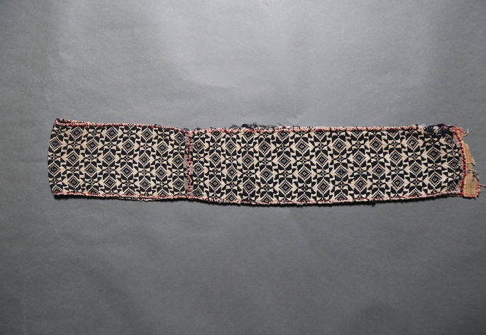 A hero shot of a hand-woven belt/headcloth inspired by traditional Tinguian blanket design