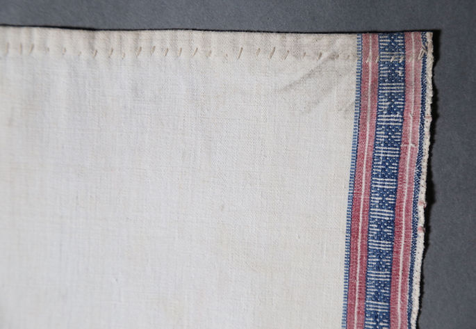 A focused shot on the stitched weft ends to prevent it from unraveling