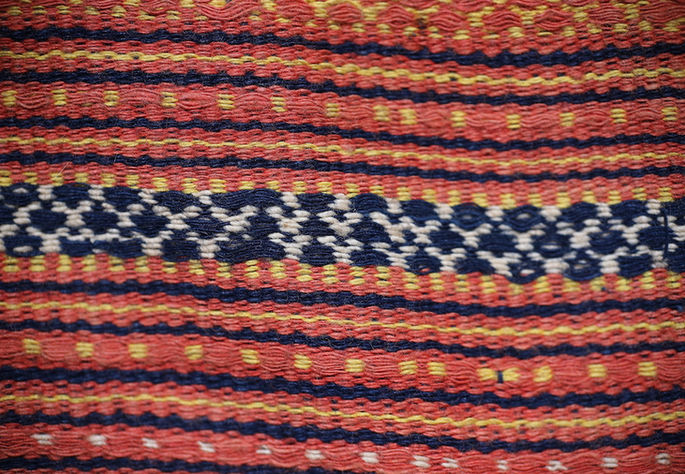 A detailed shot featuring net-like diamond motifs woven into an indigo stripe