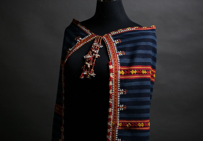 A display shot of the tapet worn on a mannequin with three panels and a secured front tie closure