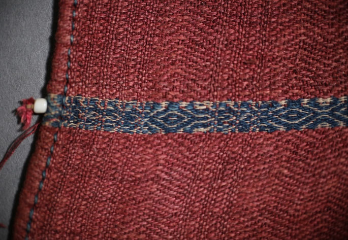 A feature shot showing the stitched hemlines with a bead attached