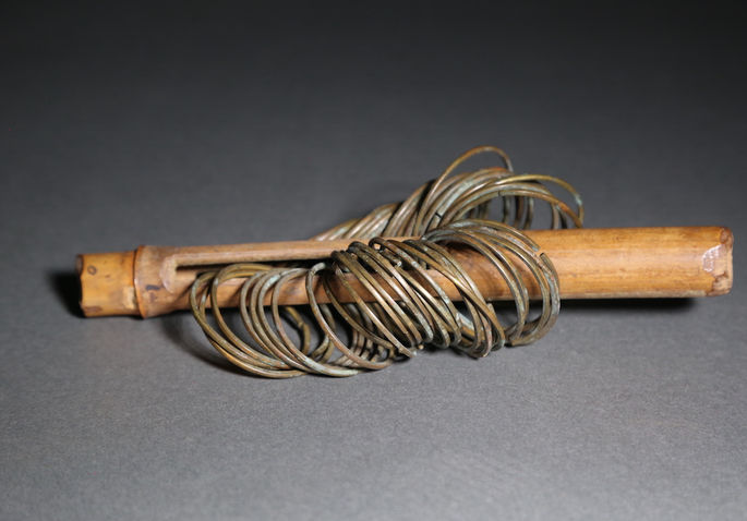 One internode of bamboo is used as the holder for the brass bracelet