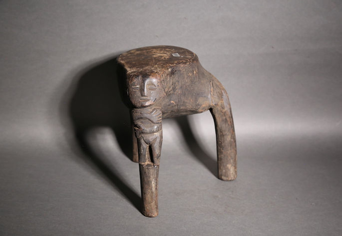 A hero shot featuring a small wooden stool with three legs