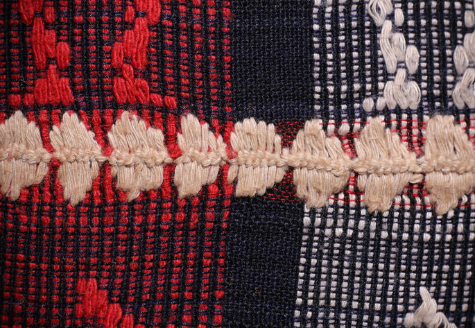 A detailed shot highlighting the white embroidered joinery.