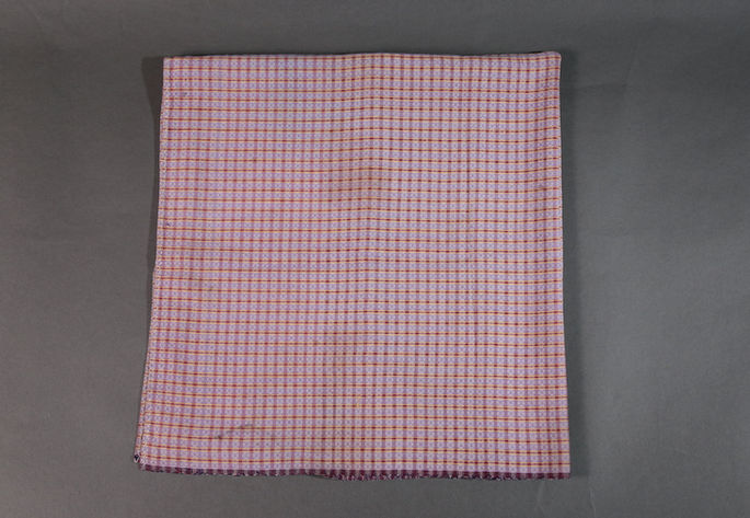 A hero shot of a two-paneled skirt with a plaid design in white, lilac, magenta, and yellow