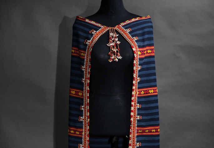A display shot of the tapet worn on a mannequin with three panels and a secured front tie closure
