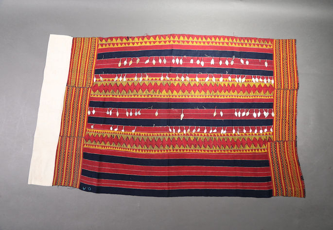 A hero shot of a wrap-around skirt with striped patterns, adorned with embroidery and beadwork
