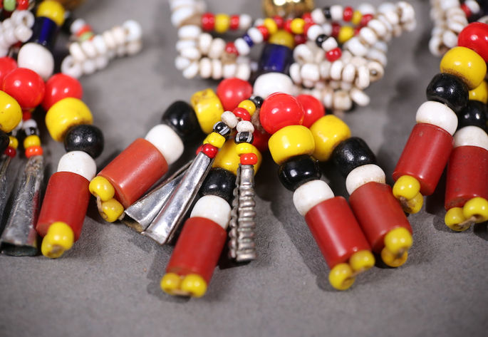 A focused shot showcasing the elongated silver charms dangling at the bottom