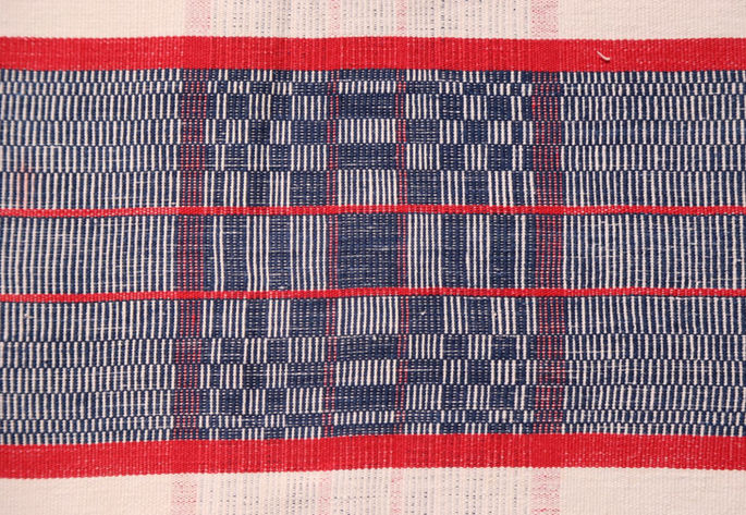 A detailed shot highlighting the red stripes design overlapping with the binakol motif.