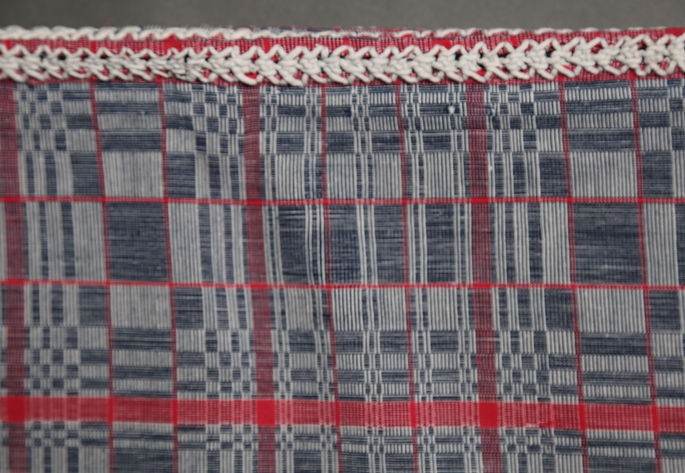 Two long zigzag embroidery motifs facing each other serve as the joinery for the blanket’s panels