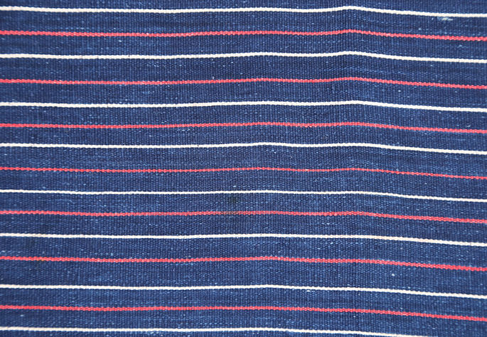 A closer look at the narrow stripe designs in colors red and white, set against an indigo background
