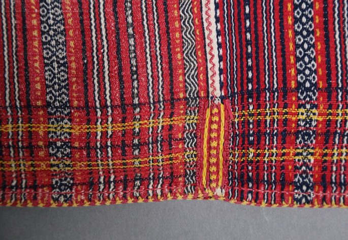 Red and yellow stitches and embroideries at the side edges