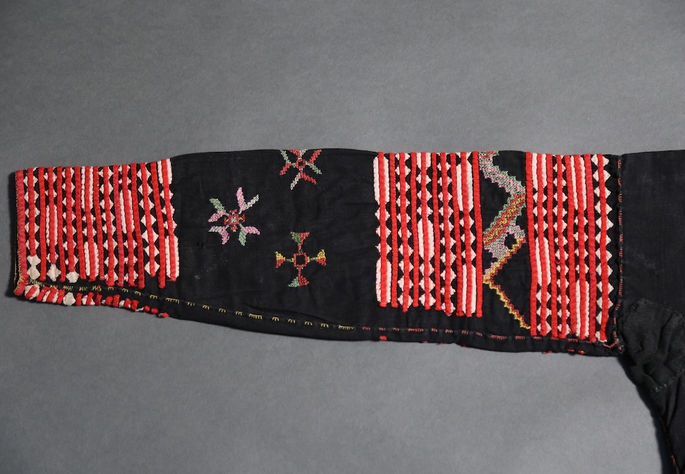 Detail of one sleeve, showing appliqué and embroidery