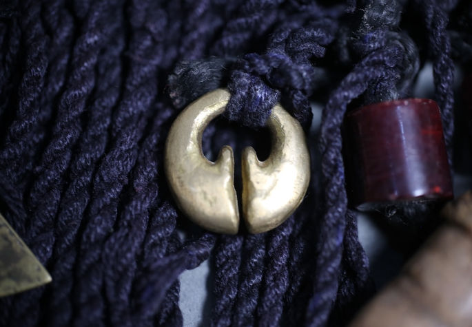 A close-up shot of the ling-ling-o brass pendant