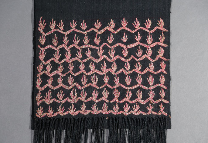 An overview of the embroidery design on the textile.